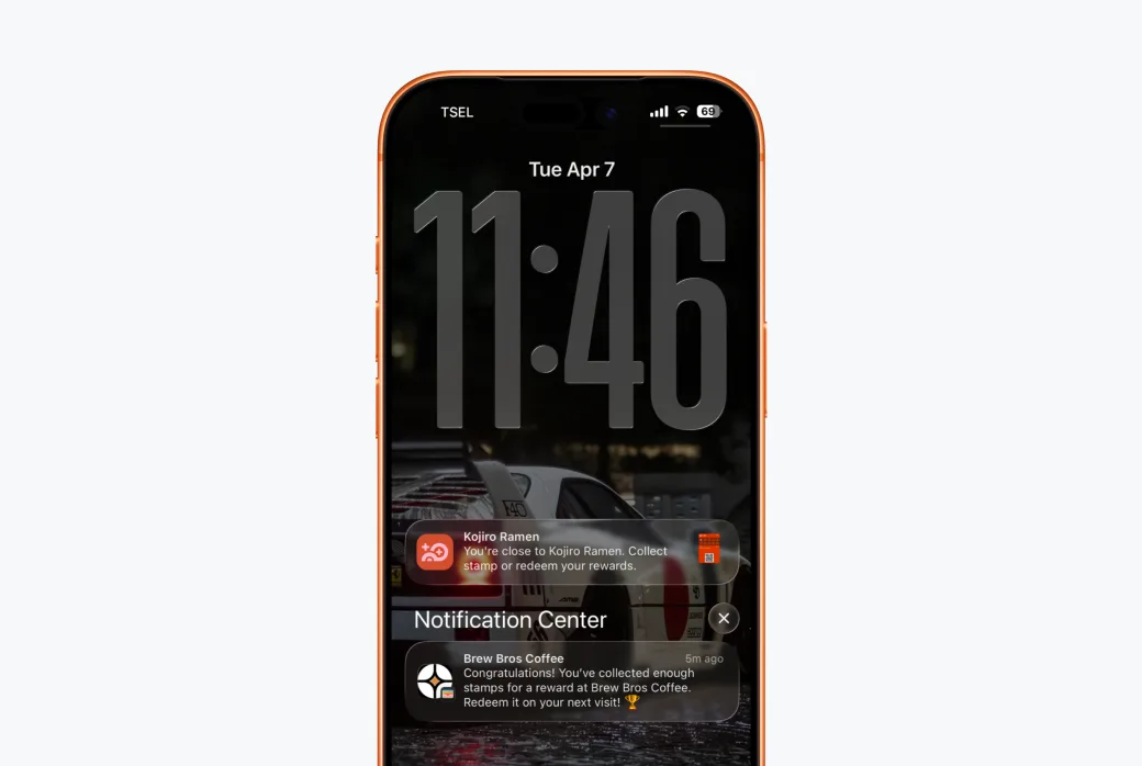 Screenshot of a phone lock screen showing a wallet push notification from a business (e.g. 'Double stamps today!').